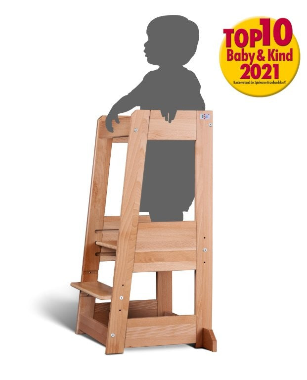 Natural wooden learning tower Felix by tiSsi®, child standing safely to help in the kitchen, award-winning design 2021