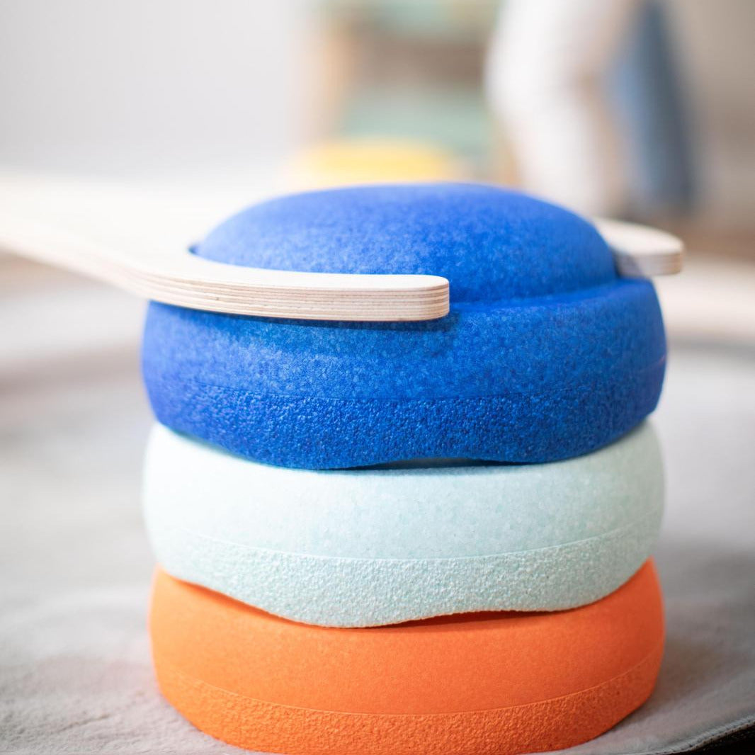 Close-up of colorful stacking boards balanced on top of each other for creative play and motor skill development